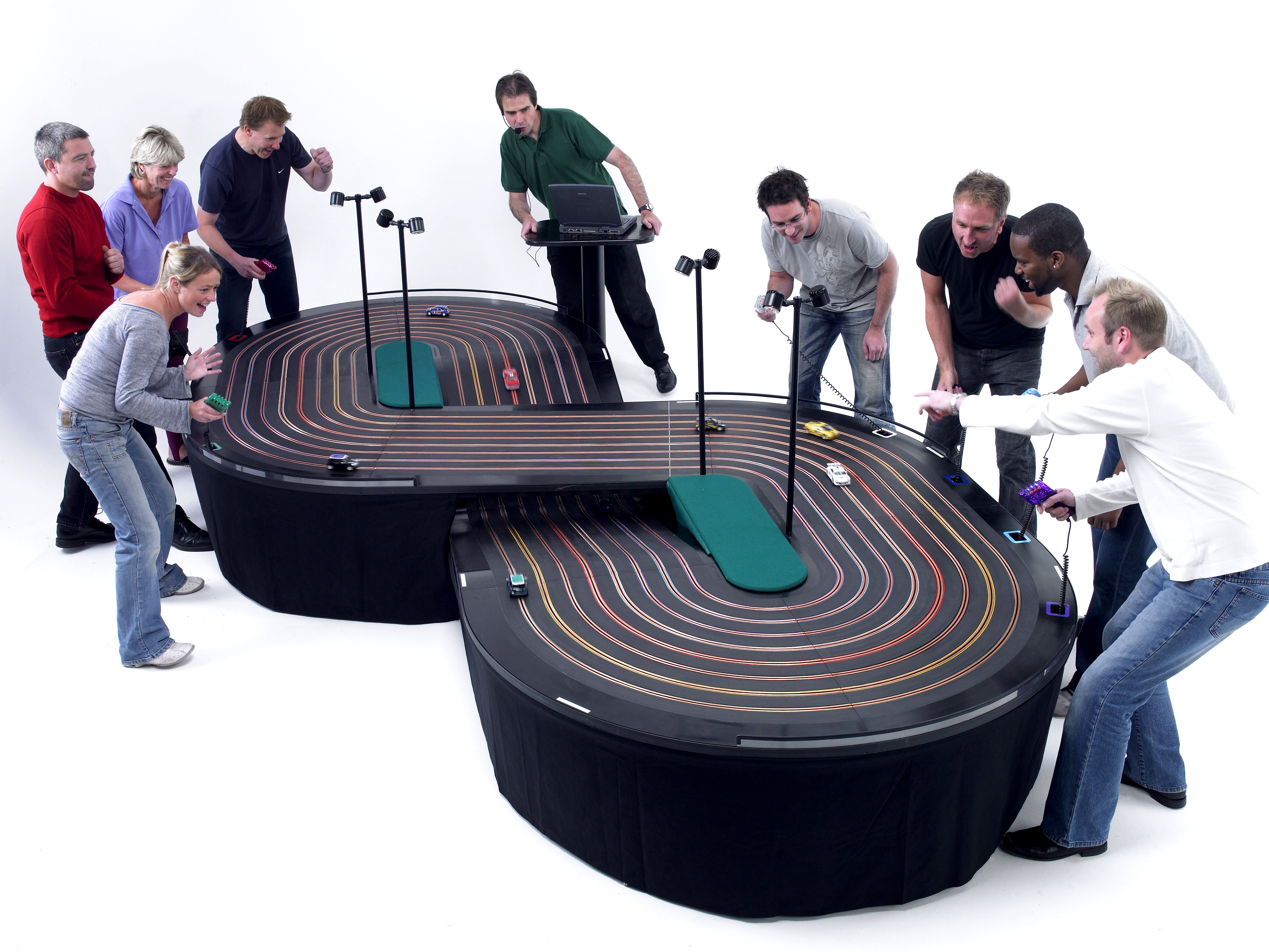 miniracing.com giant 8 lane scalextric track being used in a competition at an event